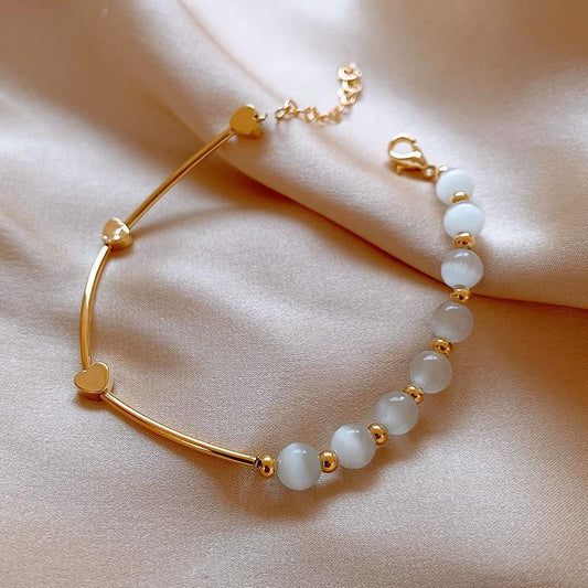 Bracelet with white opal stones and gold-plated hearts