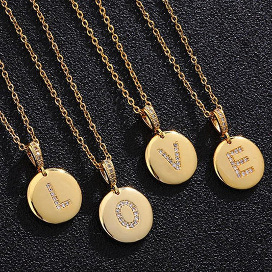 Round letter amulets in gold and zircon gold plated necklaces