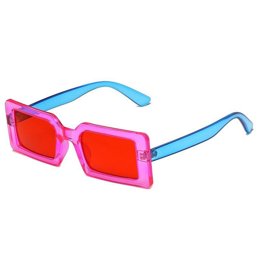 Trendy sunglasses with red lenses, pink frames and blue temples