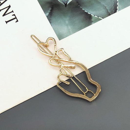 Handmade gold plated hair clip hand holding heart