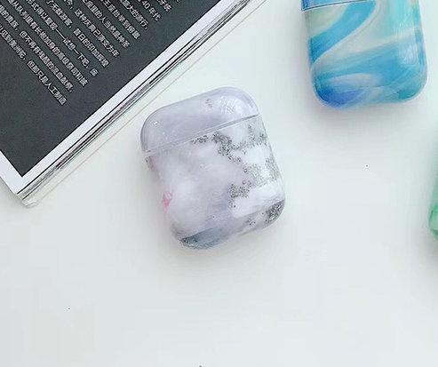 Protection for Airpods covers in pink/grey marble pattern.