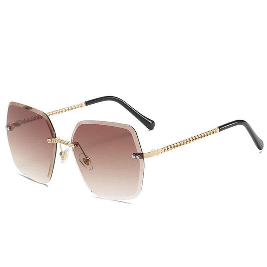 Large luxury sunglasses with beige lenses and braided gold temple without frame