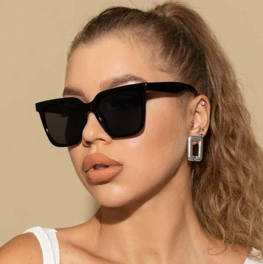 Large stylish sunglasses with square lenses and distinctive frames